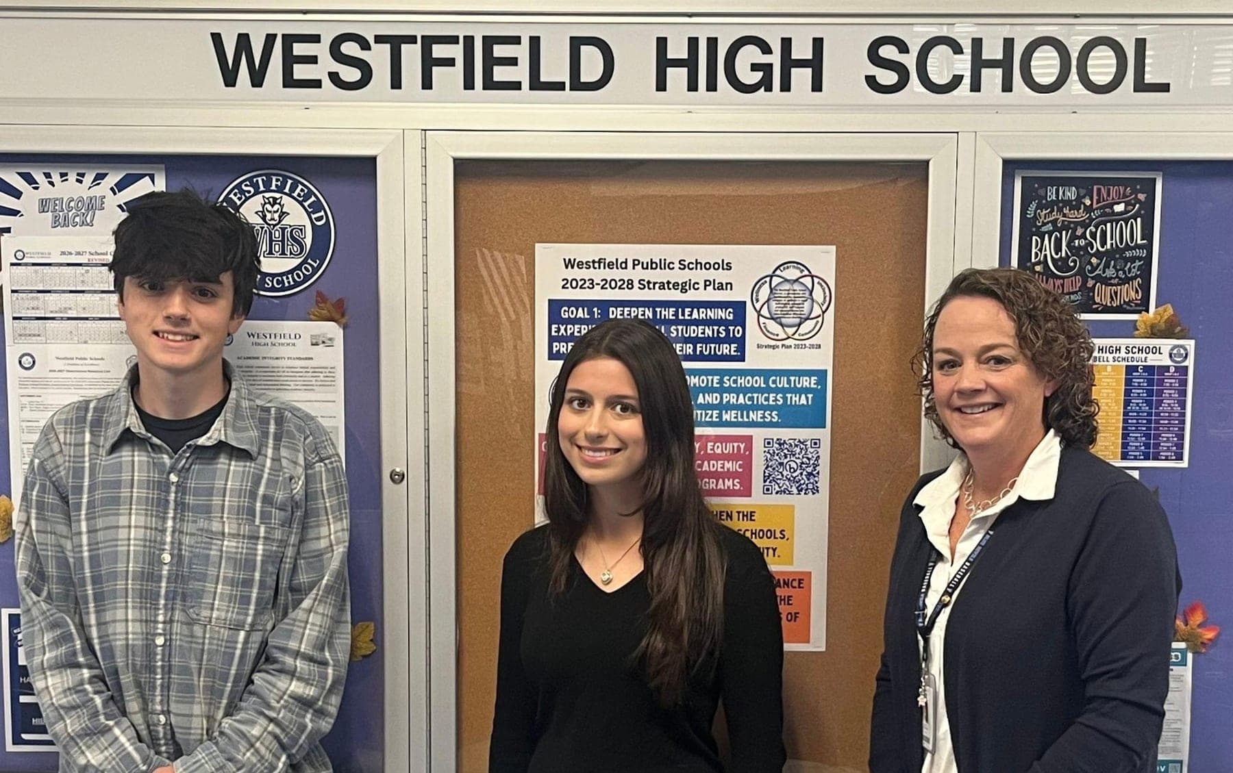 National Merit Semifinalists Alexander Stepanov and Emma Simpson with Westfield High School Principal Mary Asfendis.